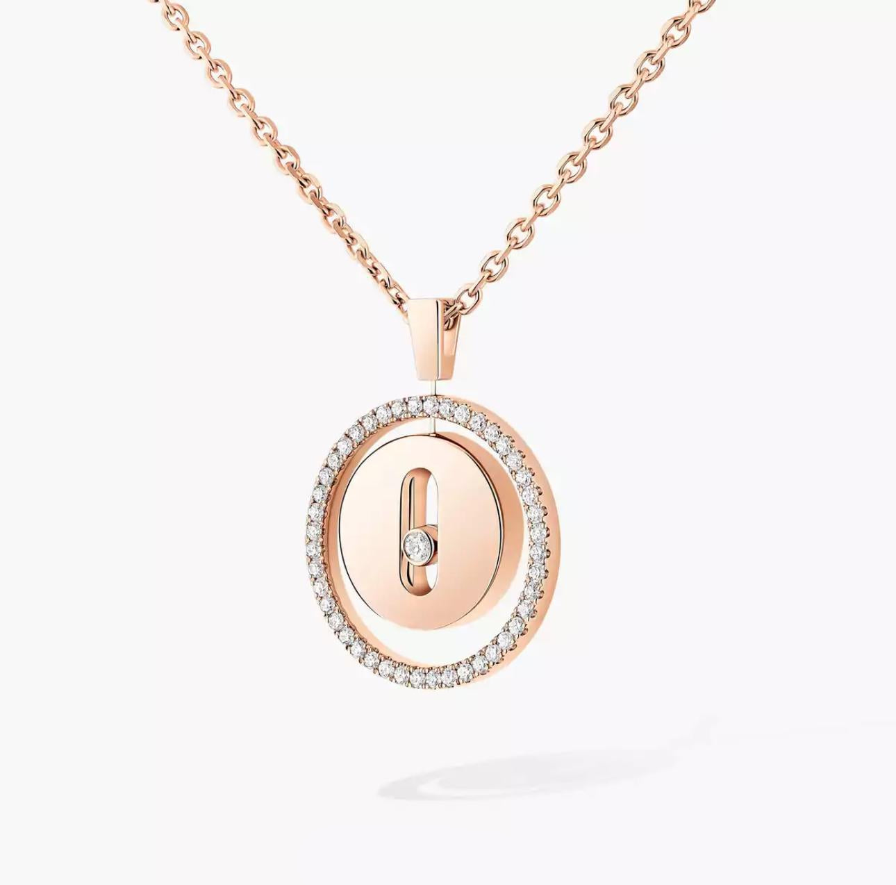 Rose gold necklace with a circular pendant on a light gray background