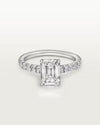 Angled studio shot of the flawless 4ct radiant-cut moissanite engagement ring, highlighting the brilliant U-cut half-eternity pavé band and 4-claw prong setting.
