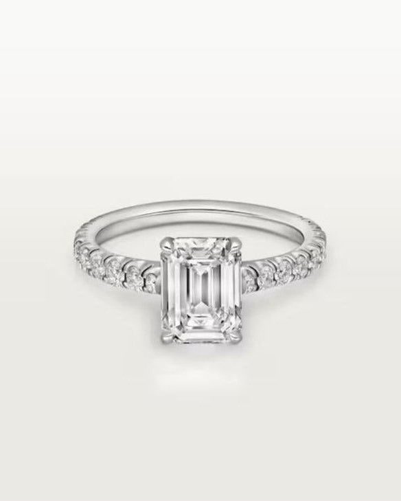 Angled studio shot of the flawless 4ct radiant-cut moissanite engagement ring, highlighting the brilliant U-cut half-eternity pavé band and 4-claw prong setting.