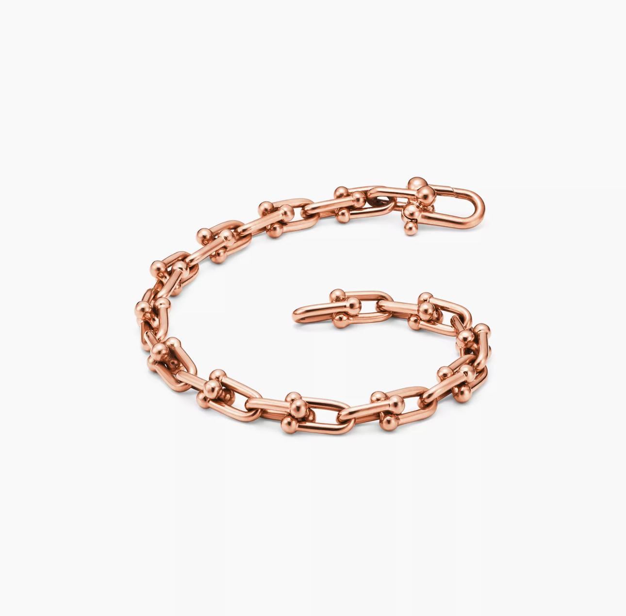 Rose gold chain bracelet on a white background