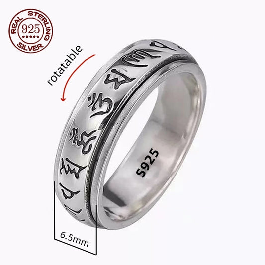 A silver spinner ring with Great Wall-inspired engravings on a double-layered band, displayed on a wooden texture background.