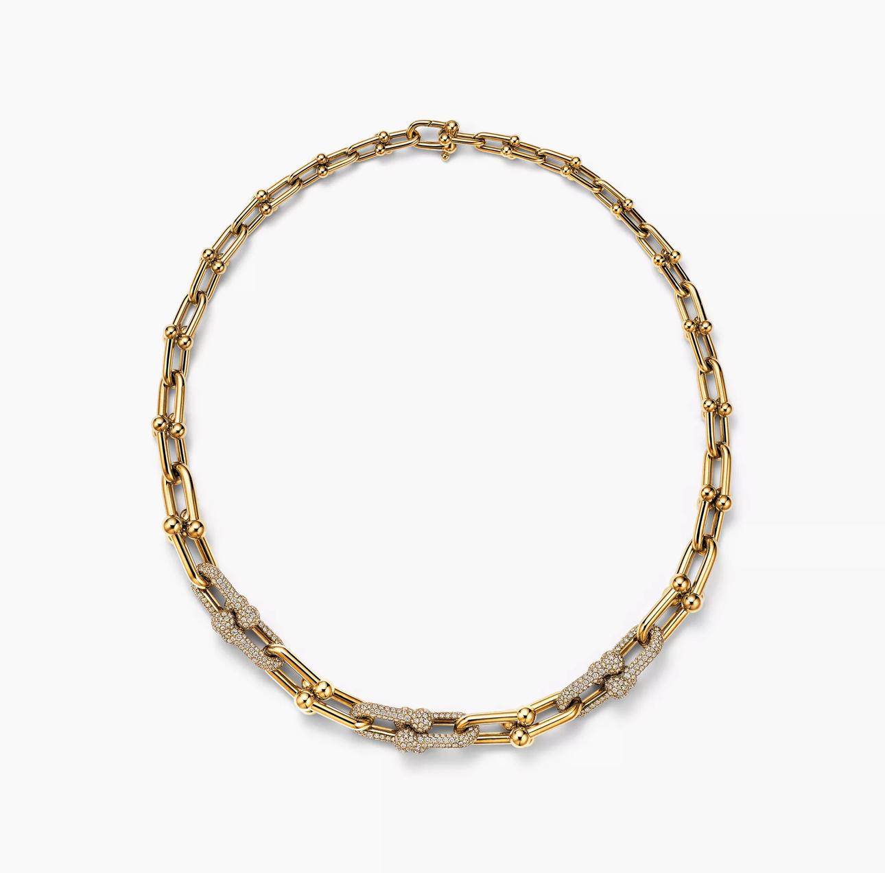 A bold 925 sterling silver necklace with yellow gold plating featuring a steampunk-inspired lock design and a bamboo-style chain.