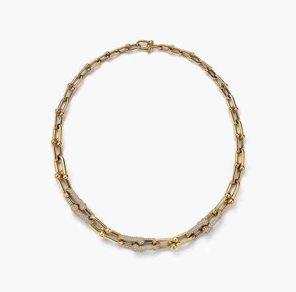 A bold 925 sterling silver necklace with yellow gold plating featuring a steampunk-inspired lock design and a bamboo-style chain.