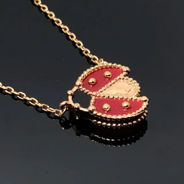 Gold and red pendant necklace on a black background
