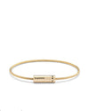 Gold bracelet with cylindrical gold tag on a white background