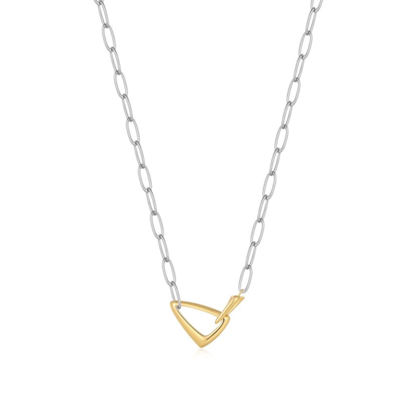 Necklace with a gold triangle pendant on a silver chain against a white background