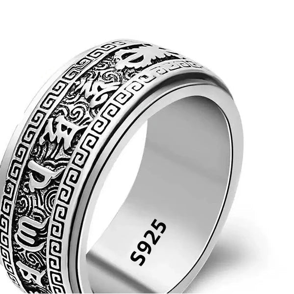 Silver ring with intricate design and '925' stamp on a white background