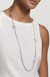 A sterling silver necklace with a four-pointed star pendant and a chain of linked stars. on a white background