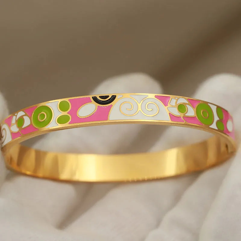 Gold bangle with colorful pattern on a neutral background