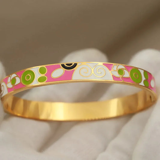 Gold bangle with colorful pattern on a neutral background