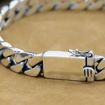 Close-up of a silver bracelet on a beige background