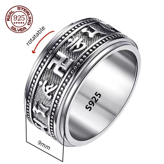 A silver spinner ring with Great Wall-inspired engravings on a double-layered band, displayed on a wooden texture background.