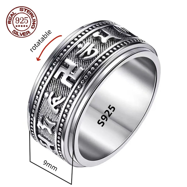 A silver spinner ring with Great Wall-inspired engravings on a double-layered band, displayed on a wooden texture background.