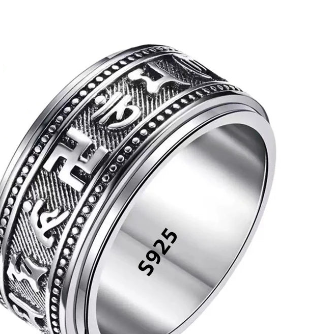 Silver ring with engraved design and '925' stamp, featuring a 'Real Sterling Silver' badge.
