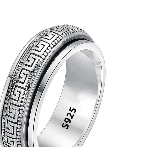 Silver ring with intricate design and '925' stamp on a white background