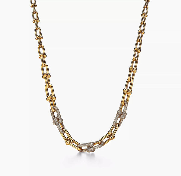A bold 925 sterling silver necklace with yellow gold plating featuring a steampunk-inspired lock design and a bamboo-style chain.