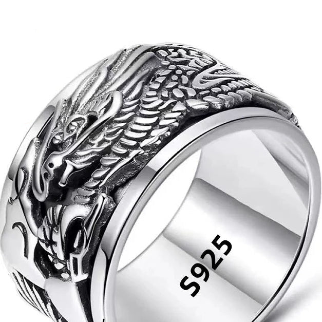 Silver ring with dragon design and '925 sterling silver' stamp on a white background