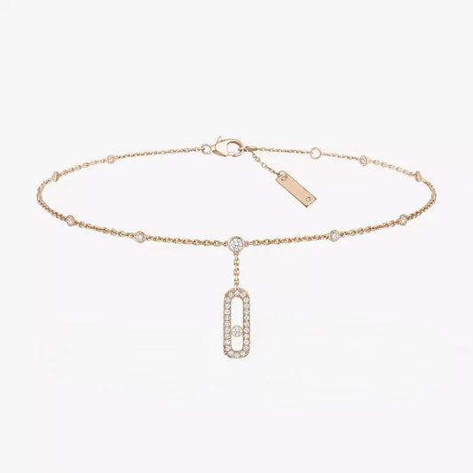 Anklet with a single zirconia crystal on a silver chain, displayed on a black glove.