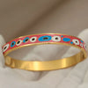 Two bangles with gold-color plating, one featuring a black background with blue eyes and floral accents, and the other with a white background showing a similar design.