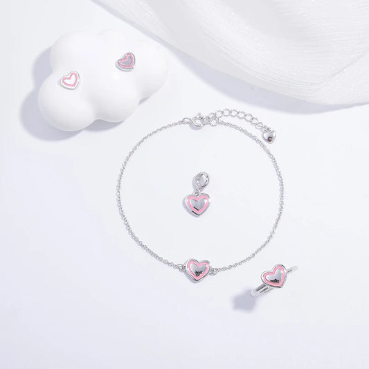 A jewelry set including a necklace, bracelet, earrings, and ring with silver and multicolored designs featuring heart and floral motifs on a white background.