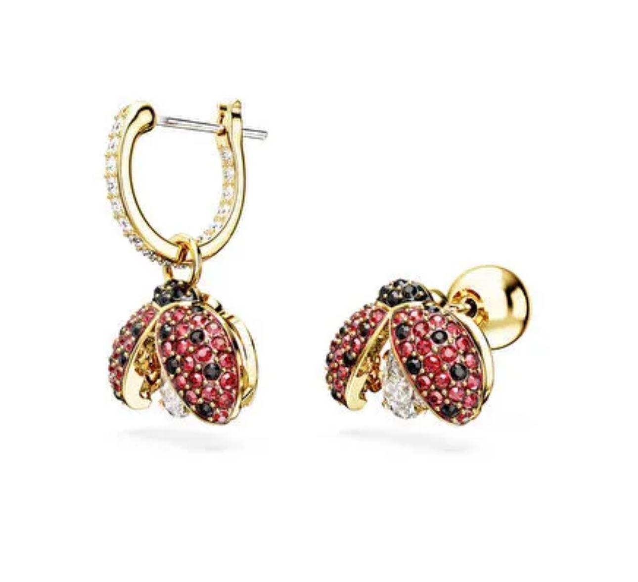 Gold hoop earrings with ladybug motif, featuring a central zircon stone and red and white accents on a gold-tone finish on a white background