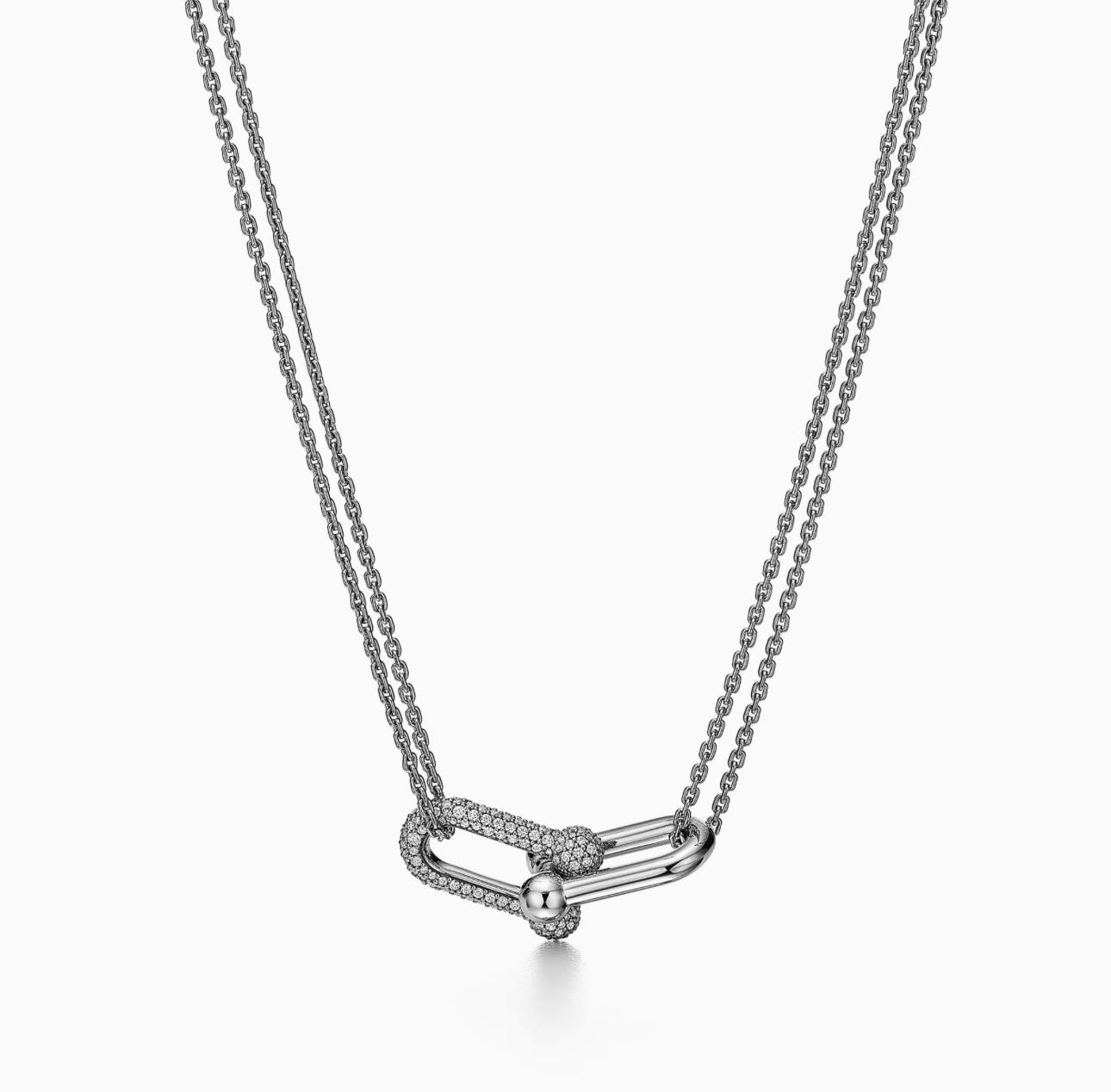 Silver necklace with a delicate pendant on a white background