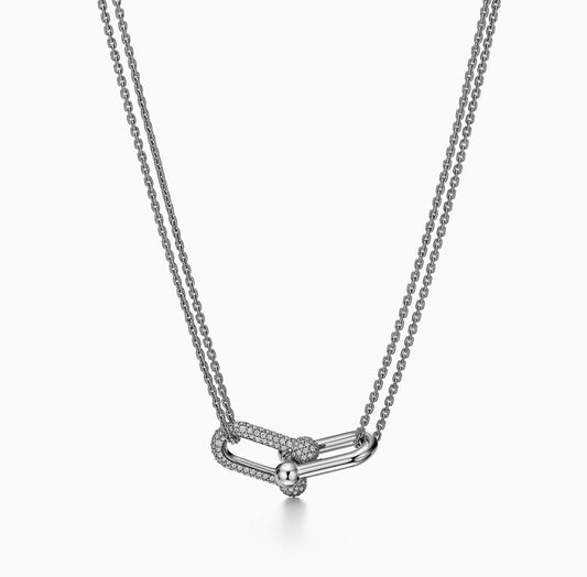 Silver necklace with a delicate pendant on a white background