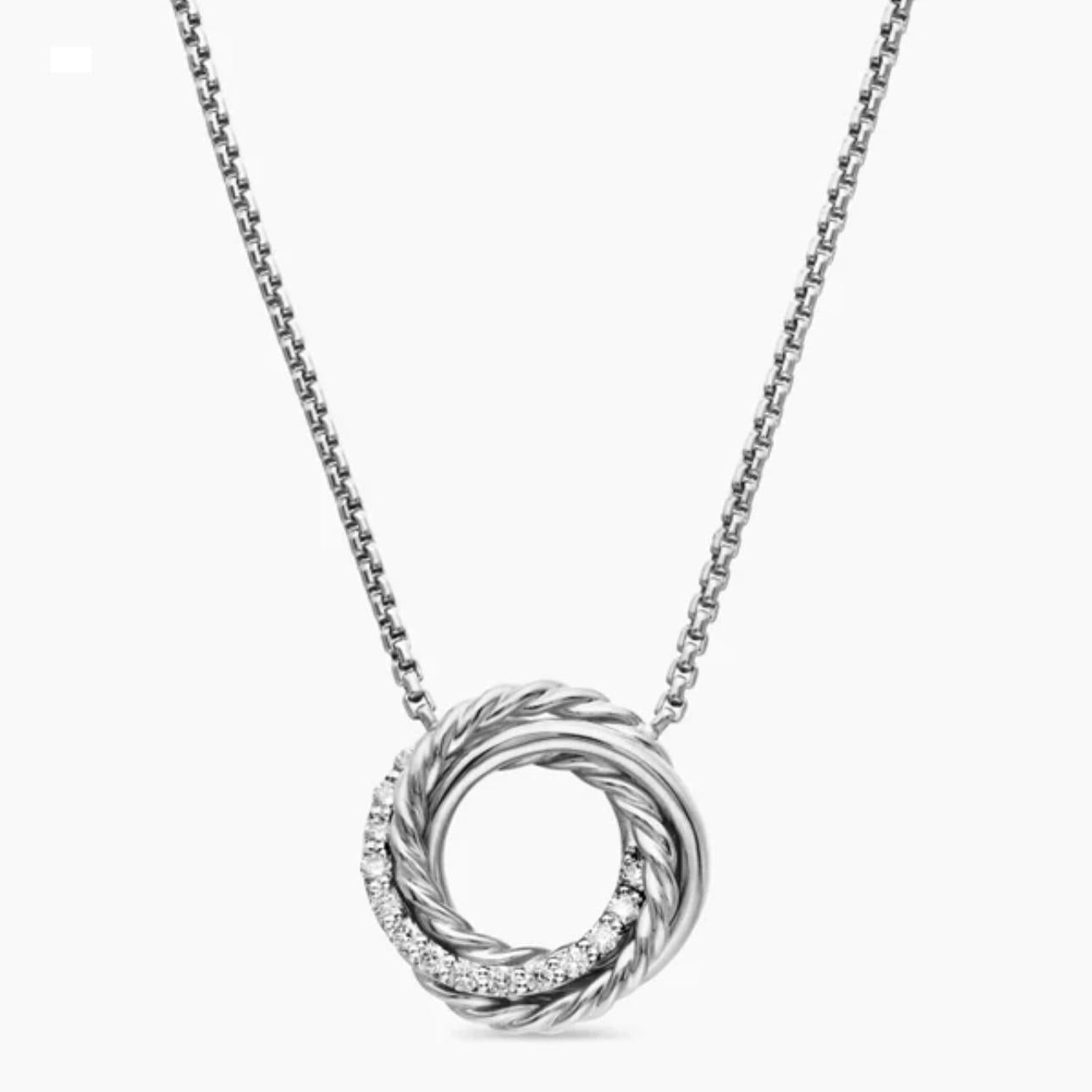 Silver necklace with a circular pendant on a white background