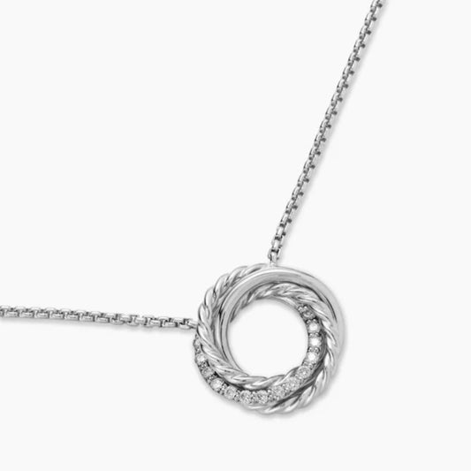 Silver necklace with a circular pendant on a white background