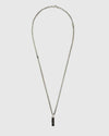 Necklace with a black pendant on a light gray background