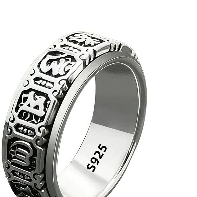 Silver ring with intricate design and '925' stamp on a white background