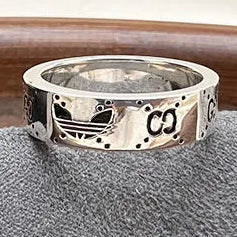 Silver ring on a gray cloth with a blurred background