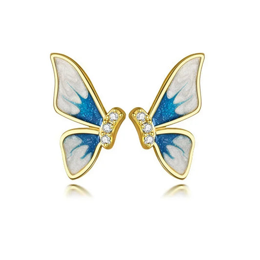 A pair of colorful butterfly stud earrings crafted from real 925 sterling silver, displayed on a beige fabric surface.