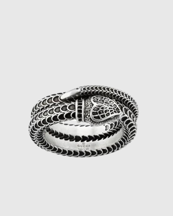 Close-up of the sculpted solid silver snake head and the coiled double-band silhouette, highlighting the antique Italian craftsmanship.