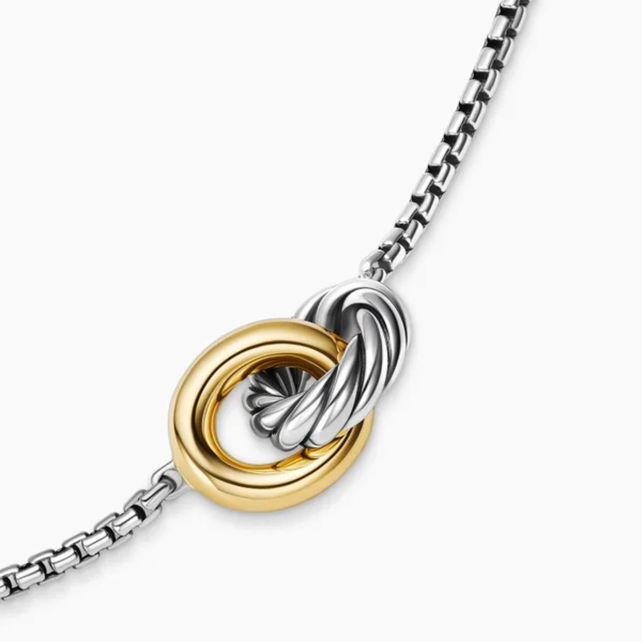Necklace with interlocking gold and silver rings on a white background