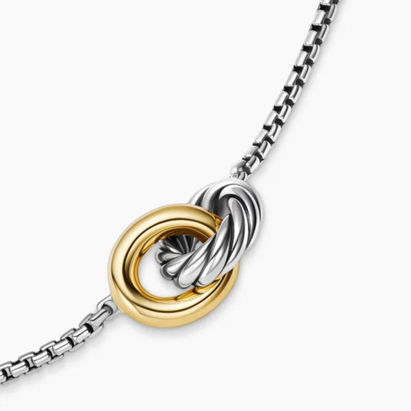 Necklace with interlocking gold and silver rings on a white background