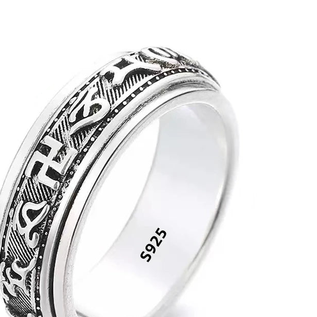 Silver ring with intricate design, marked as 925 sterling silver, on a white background.