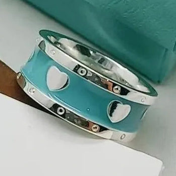 Turquoise bracelet with silver hearts on a white surface