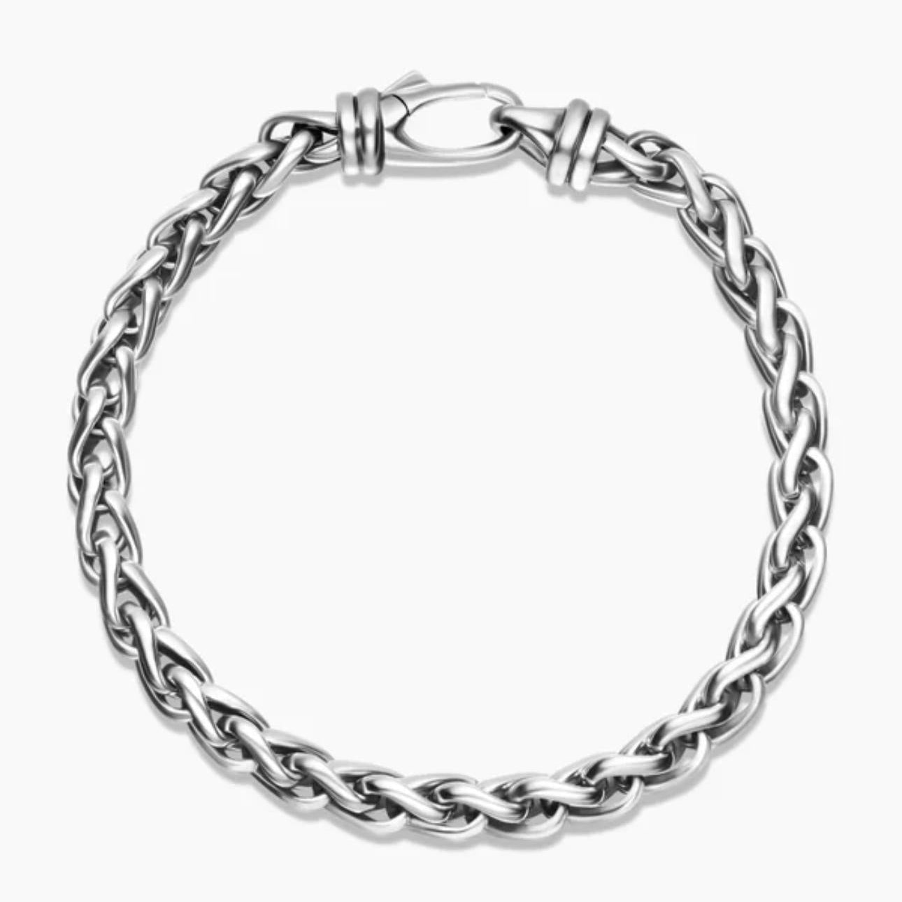 Silver braided bracelet on a white background