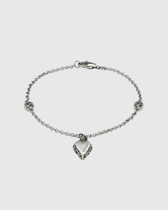 Aerion Cuore 925 sterling silver chain bracelet featuring interlocking monogram charms and an ornately engraved vintage heart pendant.
