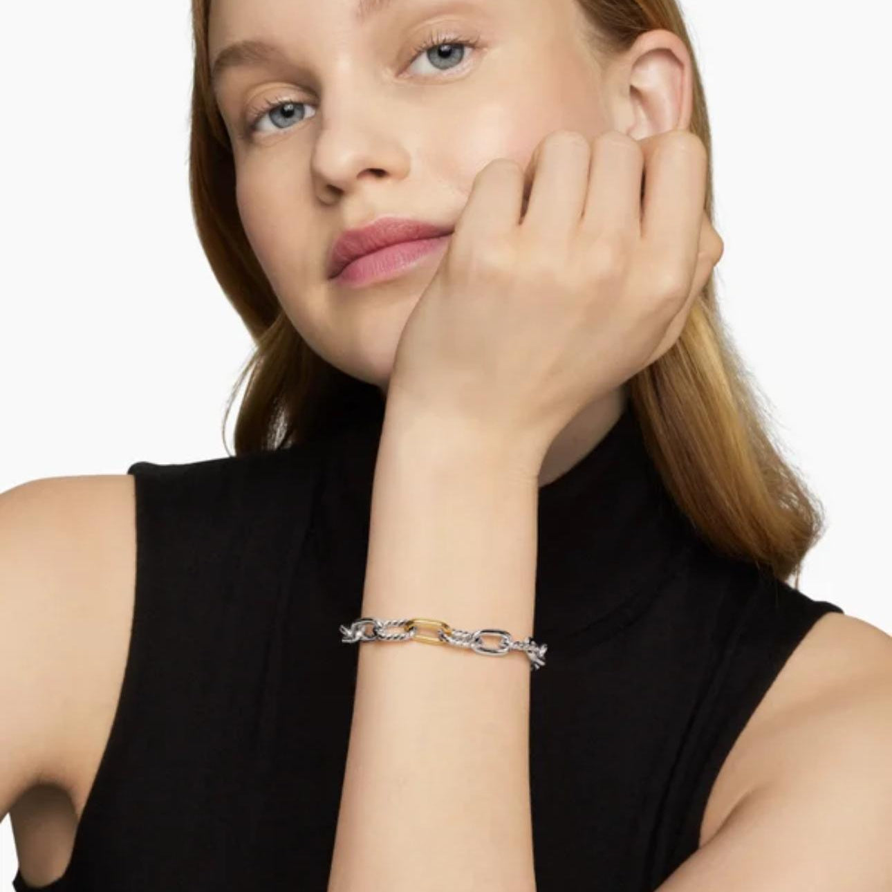 Woman wearing a bracelet on a plain background