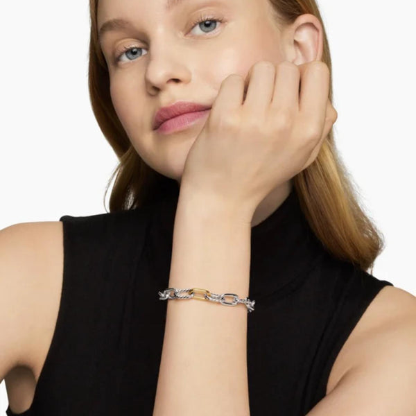Woman wearing a bracelet on a plain background