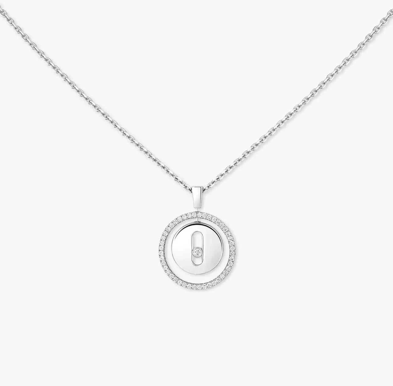 Silver necklace with a round pendant on a white background