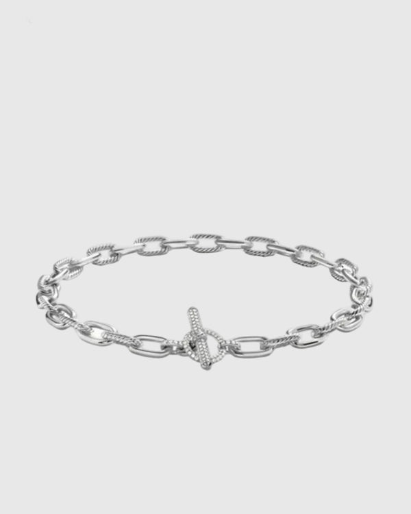 Angled view of the Claspéra Madison rhodium-plated sterling silver necklace, demonstrating the heavy, substantial feel of the 11mm architectural links.