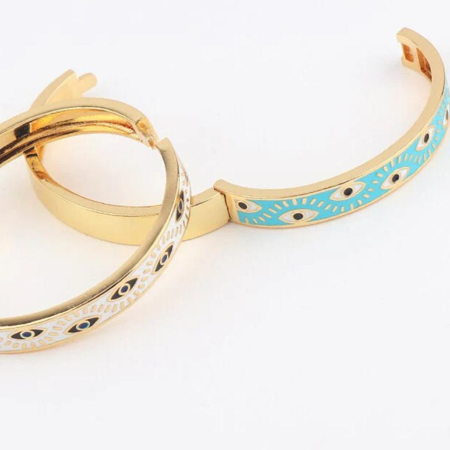 A multicolored, geometric patterned cuff bracelet with gold-plated accents, displayed against a neutral background.