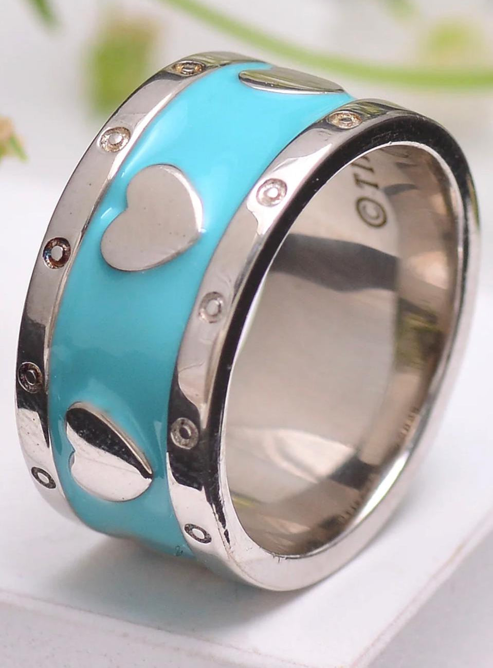 Sterling silver ring with Tiffany Blue® enamel finish with heart designs on a white background