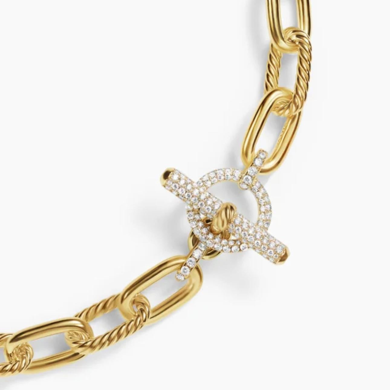 Close up Gold chain bracelet with a Pave Toggle clasp on a white background