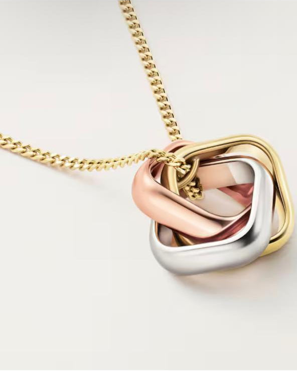 Top-down view of the solid 925 Italian silver interlocking three-ring pendant, demonstrating the fluid, seamless rolling mechanism of the tri-color metallic bands.