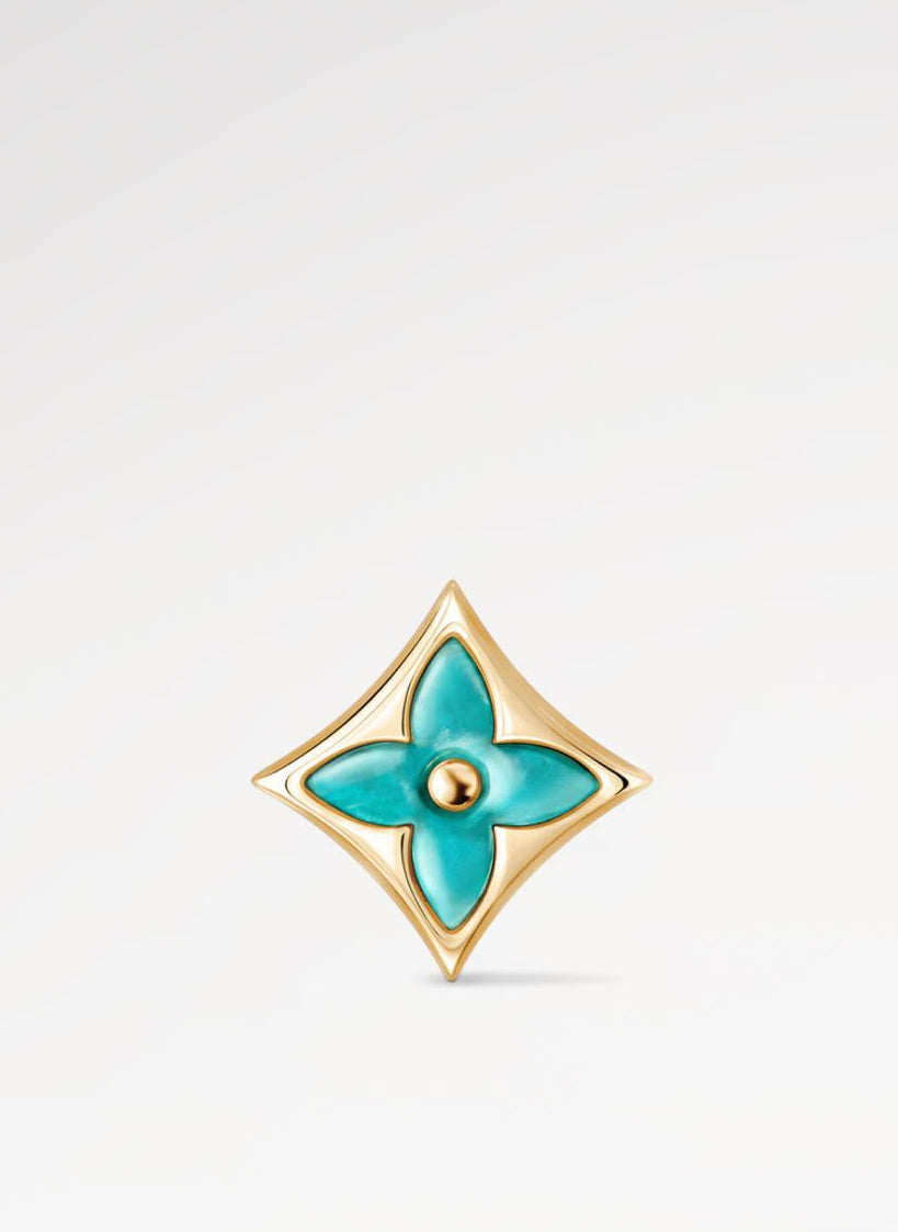 Gold and turquoise Star Ear Stud on a light gray background
