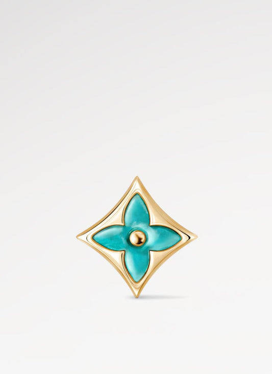 Gold and turquoise Star Ear Stud on a light gray background
